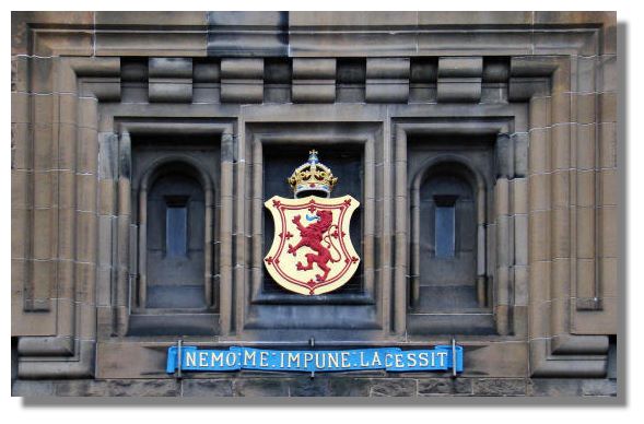 The lion rampant and the motto "Nemo Me Impune Lacessit" are displayed above The lion rampant and the motto "Nemo Me Impune Lacessit" are displayed above